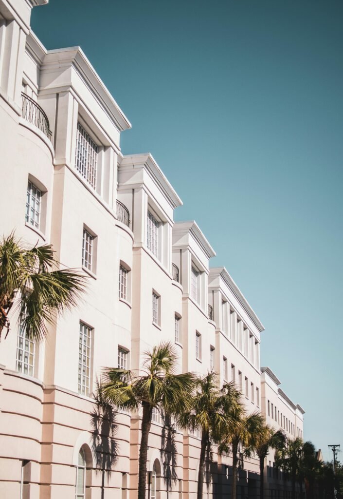 Modern apartman dairesi binası ve palmiye ağaçları ile şehir manzarası.